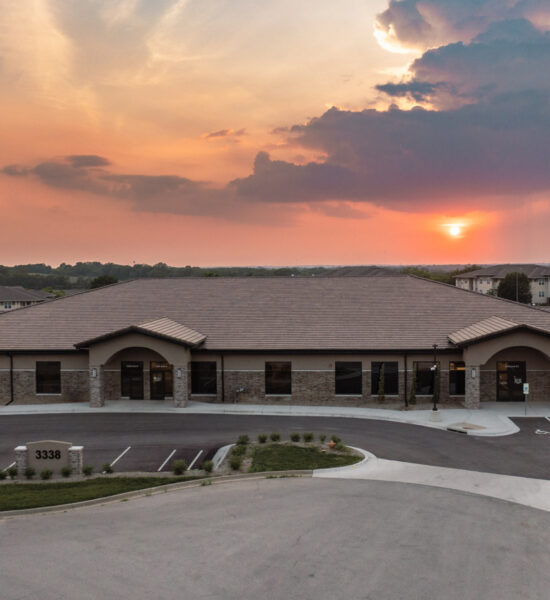 Aerial view of building with sunset in background